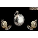 An Edwardian Sterling Silver Sovereign Case of circular form with engraved front and back,