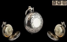 An Edwardian Sterling Silver Sovereign Case of circular form with engraved front and back,