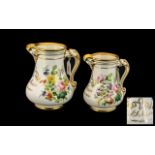 Pair of Victorian Moulded Jugs with floral decoration and gilt trim, dated 1860.