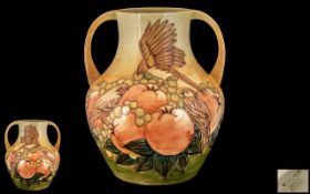 Moorcroft Large and Impressive Twin Handled Tube lined 'Fruits and Finches' Vase, with ochre ground,