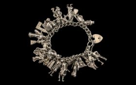 A 1960s Silver Charm Bracelet loaded with 26 good quality silver charms, some very interesting.