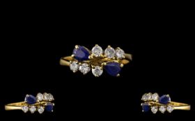 18ct Gold - Good Quality Sapphire and Diamond Set Dress Ring. Marked 750 - 18ct.