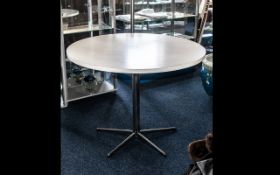 Contemporary Circular White Dining Table raised on chrome pedestal base with five star base.