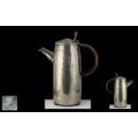 Tudric Beaten Pewter Arts and Crafts Hot Water Jug, design number 0231, with rattan covered handle,