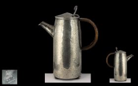 Tudric Beaten Pewter Arts and Crafts Hot Water Jug, design number 0231, with rattan covered handle,