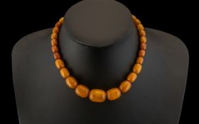 A Fine and Well Matched Graduated Butterscotch Amber Bead Necklace, with Hidden Clasp. Please
