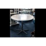 Contemporary Circular White Dining Table raised on chrome pedestal base with five star base.