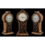 Art Nouveau Carved Oak Mantel Clock in a shaped, floral case, with a white enamel dial; Ferranti,