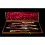 An Antique Carving Set in fitted silk lined velvet case.