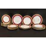 Set of Worcester Dinner Plates, various sizes, with a gilt jewelled maroon border.