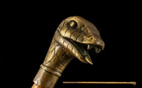 Brass Cobra Head Cane Walking Stick, the snakes tongue protruding from its mouth, ready to strike.