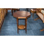 Occasional Table in Mahogany Veneer, raised on four turned legs, with lower shelf, on casters.