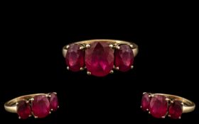 Ladies Attractive / Pleasing 9ct Gold - 3 Stone Ruby Set Dress Ring. The Rubies of Excellent Colour.