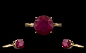 9ct Gold Attractive Single Stone Ruby Ring - Gallery Setting. The Round Faceted Ruby of Good Colour.