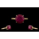 9ct Gold Attractive Single Stone Ruby Ring - Gallery Setting. The Round Faceted Ruby of Good Colour.