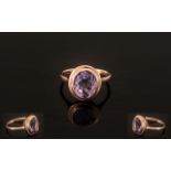 Rose de France Amethyst Solitaire Ring, a bezel set, oval cut,