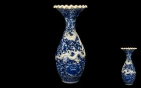 Large Japanese Meiji Period Embossed Dragon Vase with floral decoration in underglaze blue and an