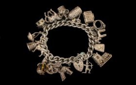 A Good Quality Sterling Silver Charm Bracelet Loaded with 15 Silver Charms.