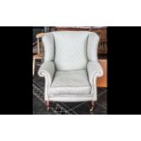 Modern Laura Ashley Style Wing Armchair on small turned wooden legs with brass castor, covered in