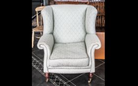 Modern Laura Ashley Style Wing Armchair on small turned wooden legs with brass castor, covered in