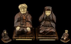 Pair of Art Deco Period French Macassar Wood and Ivory Carvings of a Seated Arab Man and Wife,