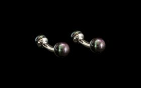Fresh Water Peacock Pearl Cufflinks, each comprising a solid, curved, silver bar set with two