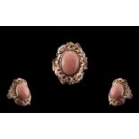 Pink Opal and Pink Sapphire Statement Ring, an oval cut cabochon of pink opal, measuring 7cts, set