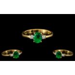 18ct Gold Attractive Emerald and Diamond Set Ring, the central, oval shaped,