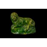 Antique Whieldon Type Green Glazed Recumbent Lion on a hollow moulded base;