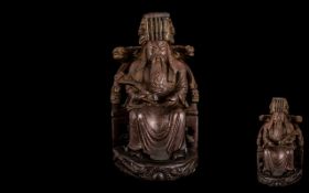 Antique Chinese Finely Carved Cherrywood Figure of a Seated Mandarin wearing a traditional hat with