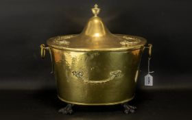 Victorian Coal Bucket. Antique coal bucket in hammered brass, raised on four claw feet.