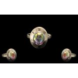 Mercury Mystic Topaz Solitaire Ring, a 3.25ct oval cut Mercury mystic topaz solitaire set in a