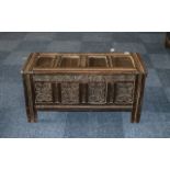 An Oak Panelled Coffer of traditional peg construction, panelled hinged top, front, sides and