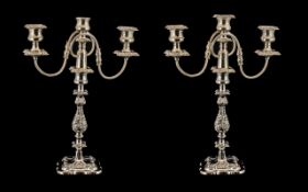 A Pair of Silver Plated Decorative Two Branch Three Light Candleabras of molded floral and scroll