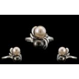 14ct White Gold Black and White Pearl Set Dress Ring, With Tiny Diamond Shoulders.