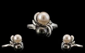 14ct White Gold Black and White Pearl Set Dress Ring, With Tiny Diamond Shoulders.