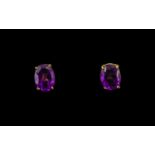 Pair of Oval Shaped Amethyst Set Stud Earrings, length 8 mm.