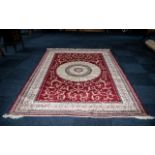 A Large Woven Silk Carpet Abusson rug with red ground and with traditional floral and foliate border
