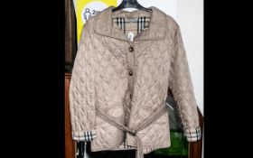 Burberry of London Ladies Jacket, beige, diamond quilted style with belt, two flap pockets, and