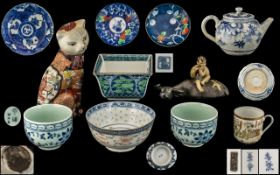 Eleven Various Oriental Items comprising a small tea pot, a small boy riding a water buffalo,