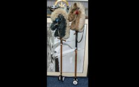 Pair of Vintage 1960s Child's Hobby Horses on poles, terminating on wheels. Measure 43" in length.