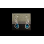 9ct White Gold Drop Earrings Set with Pear Shaped Blue Topaz & Diamond Chips, fully hallmarked.