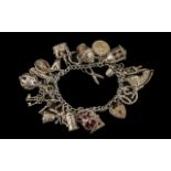 Heavy Silver Charm Bracelet. Good silver charm bracelet loaded with lots of interesting charms.