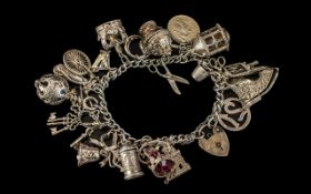 Heavy Silver Charm Bracelet. Good silver charm bracelet loaded with lots of interesting charms.