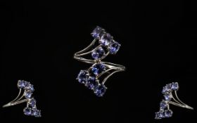 Tanzanite Crossover Cluster Ring, 3cts of oval cut tanzanites set in a 9ct white gold shank which