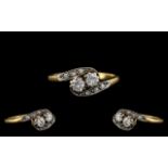 Art Deco Period Attractive Two Stone Diamond Ring of pleasing design. Marked 18ct.