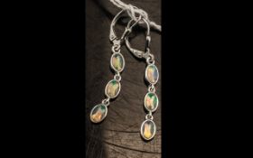 Natural Opal Triple Drop Earrings, each earring comprising three oval cut cabochons of natural opal,