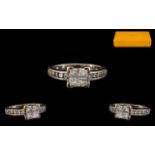 18ct White Gold Diamond Ring set with four central Princess cut diamonds between diamond cut