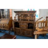 Edwardian Carved Oak Court Cupboard with a panelled top supported by four spindles,