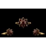 9ct Gold Garnet Set Ring, with a flower head design. Ring Size L.